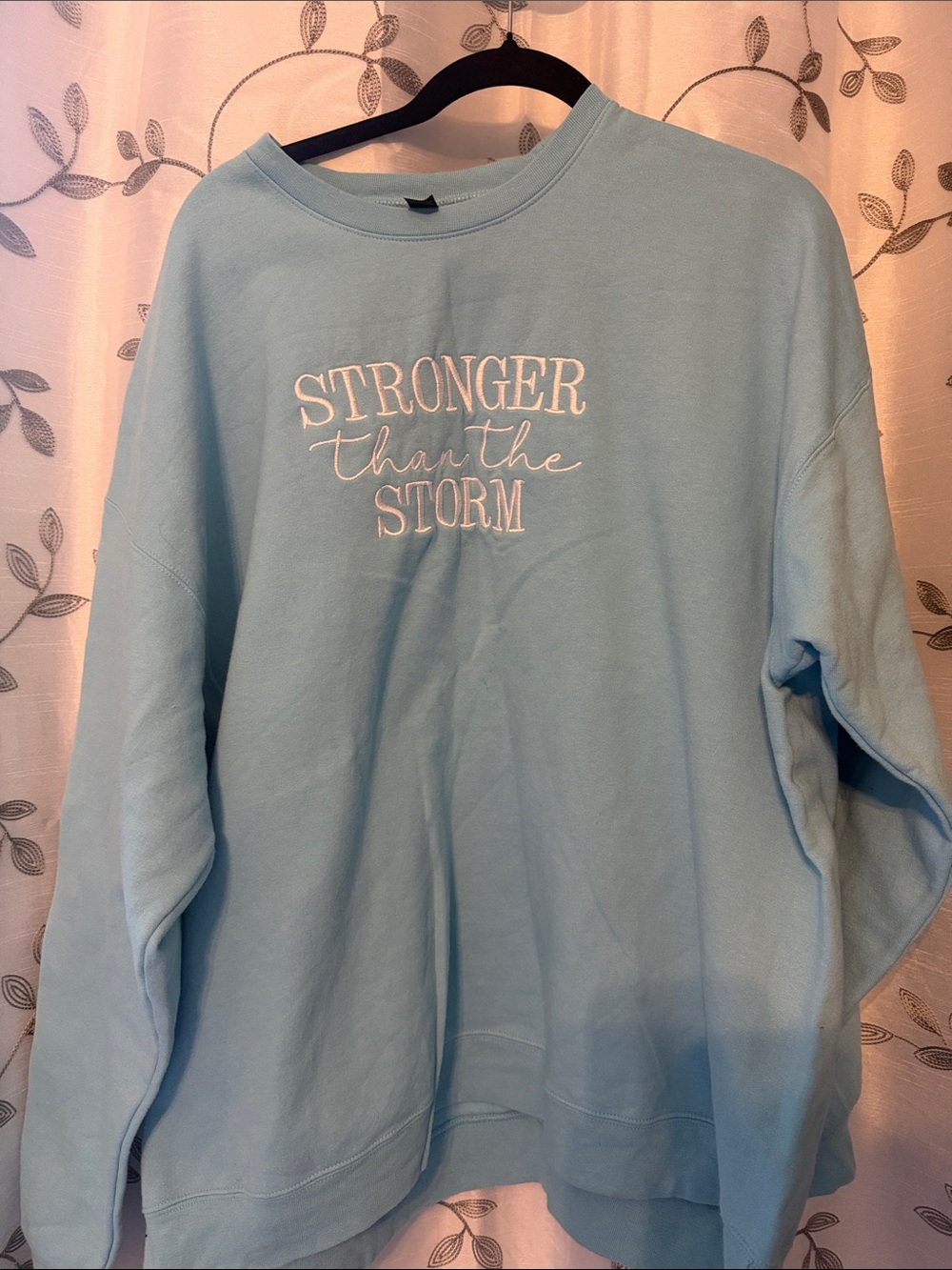 Stronger Than The Storm Light Blue Women’s Sweatshirt